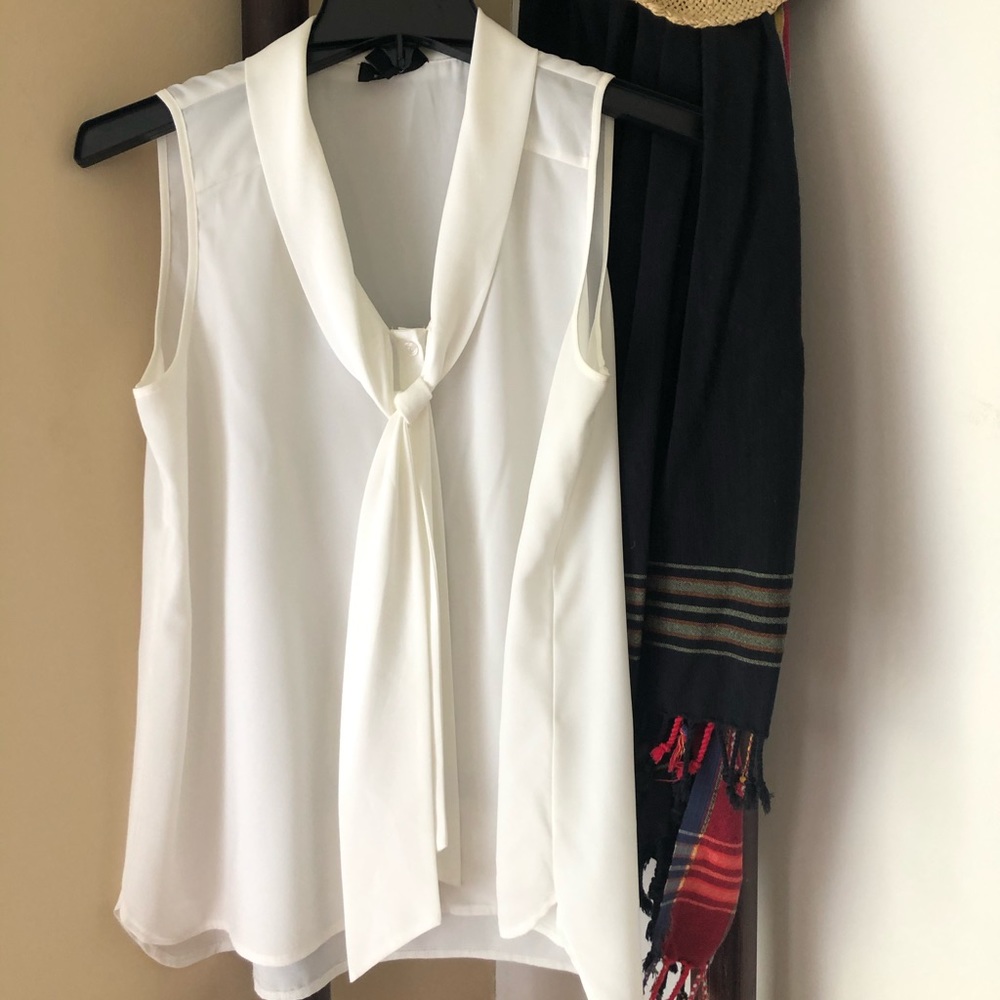 Sleeveless, attached wrap around neck blouse